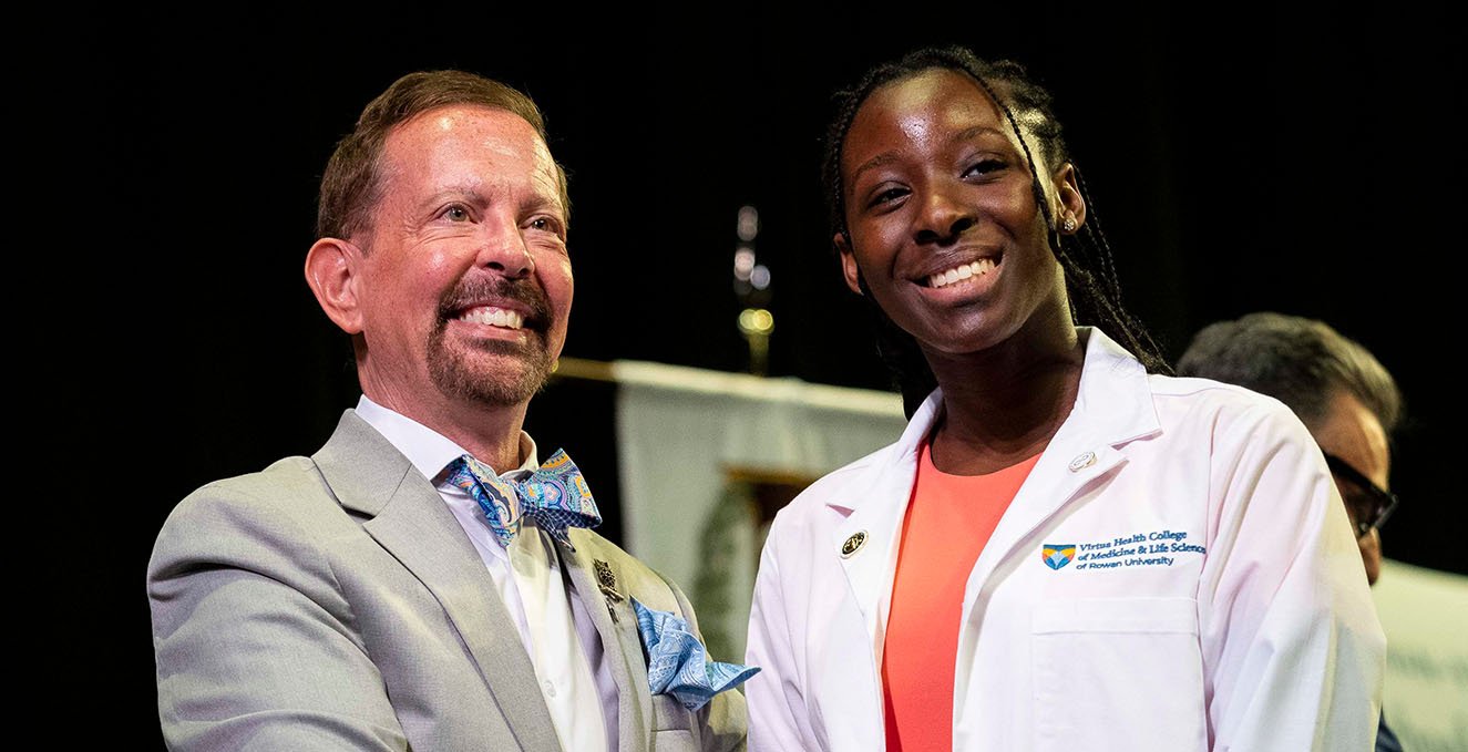 Dr. Jermyn smiles with a medical student at the white coat ceremony