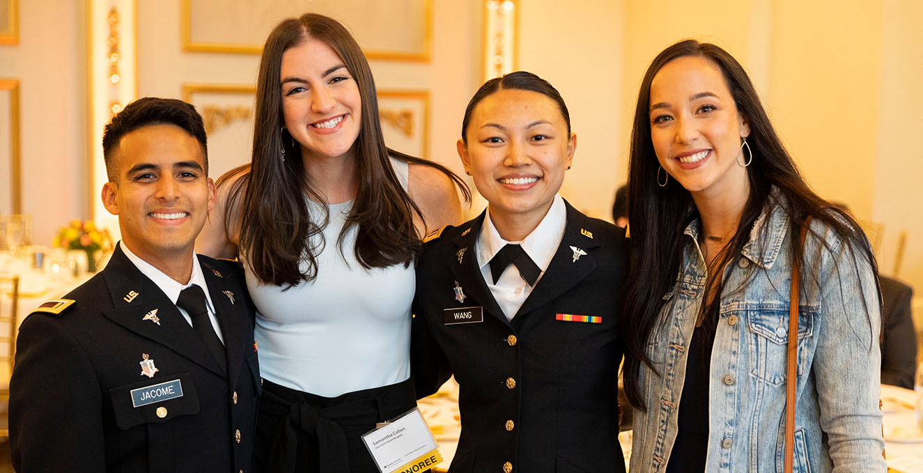 Four Rowan-Virtua SOM student, two of them in the military, smile at the camera