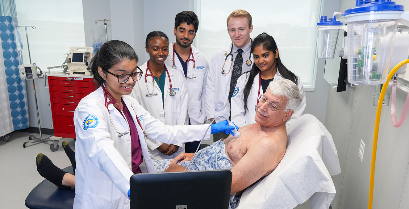 a group of med students work together with a standardized patient