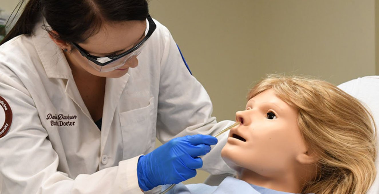 a med student works in the sim lab