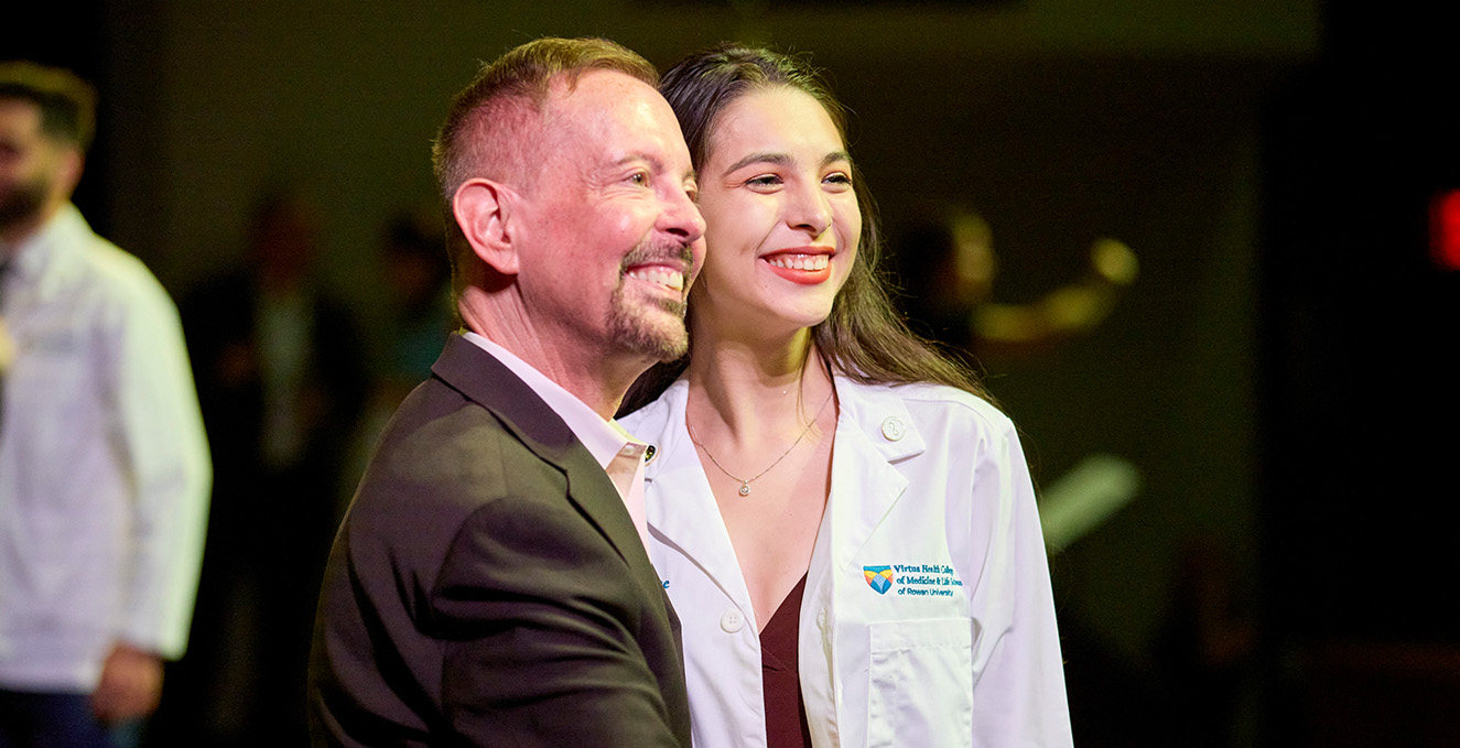 Dean Jermyn congratulates a medical student during the white coat ceremony