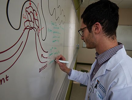 med student at whiteboard