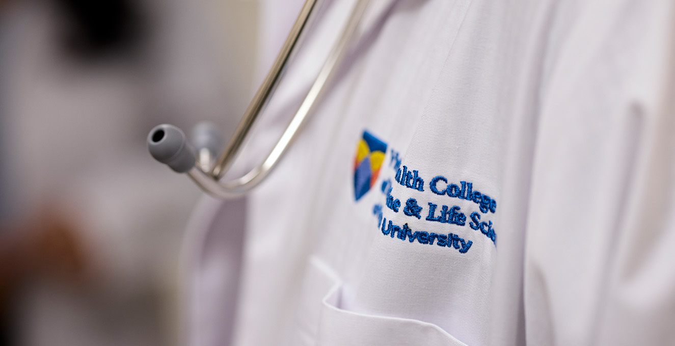 a stethoscope hangs next the the VHC logo on a white coat