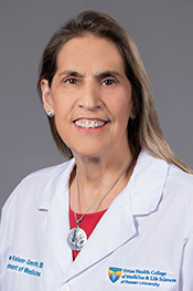 Joanne Kaiser-Smith wearing a white coat and smiling