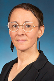 Rachel Silliman Cohen looks at the camera while wearing glasses and a dark blouse