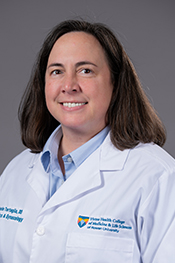 Michele Tartaglia smiles at the camera while wearing her white coat