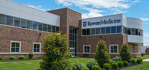 the exterior of the Rowan Medicine building in Sewell, NJ. Rowan Medicine is written in Blue on the building