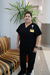 Judy Guio smiling while standing in the Academic Center