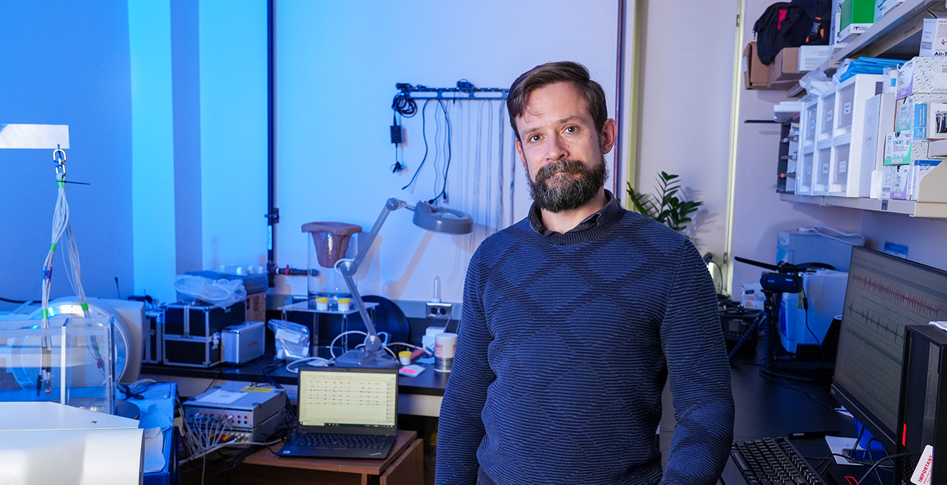 Dr. Francois Gould smiles while standing in his lab